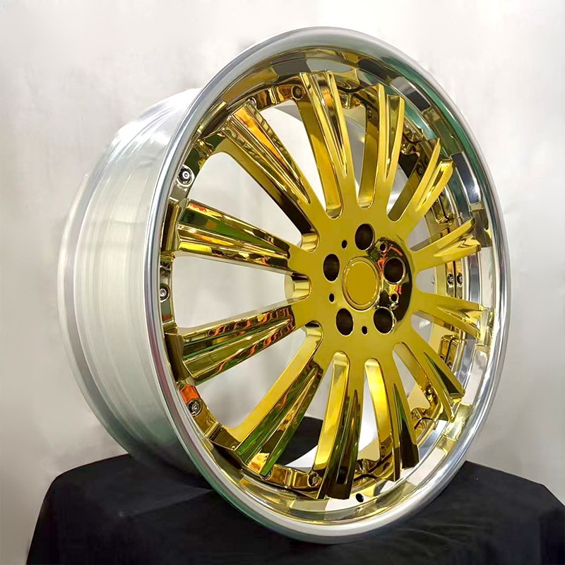 Two-piece forged wheel with gold-tone electroplated center and polished rim, three-quarter view